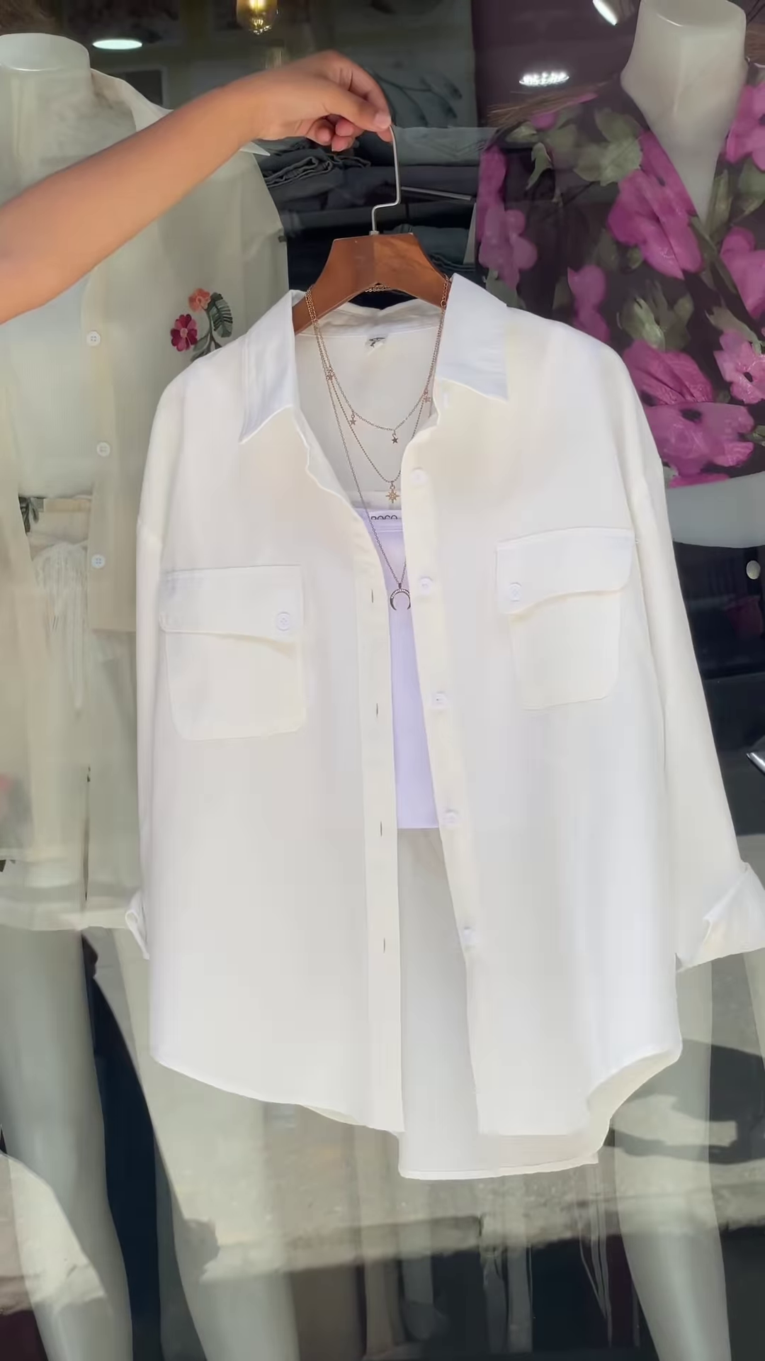 White Embroidered Shirt with Layered Styling – Boutique Elegance in a Window Display