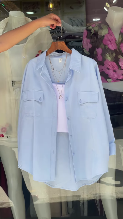 White Embroidered Shirt with Layered Styling – Boutique Elegance in a Window Display
